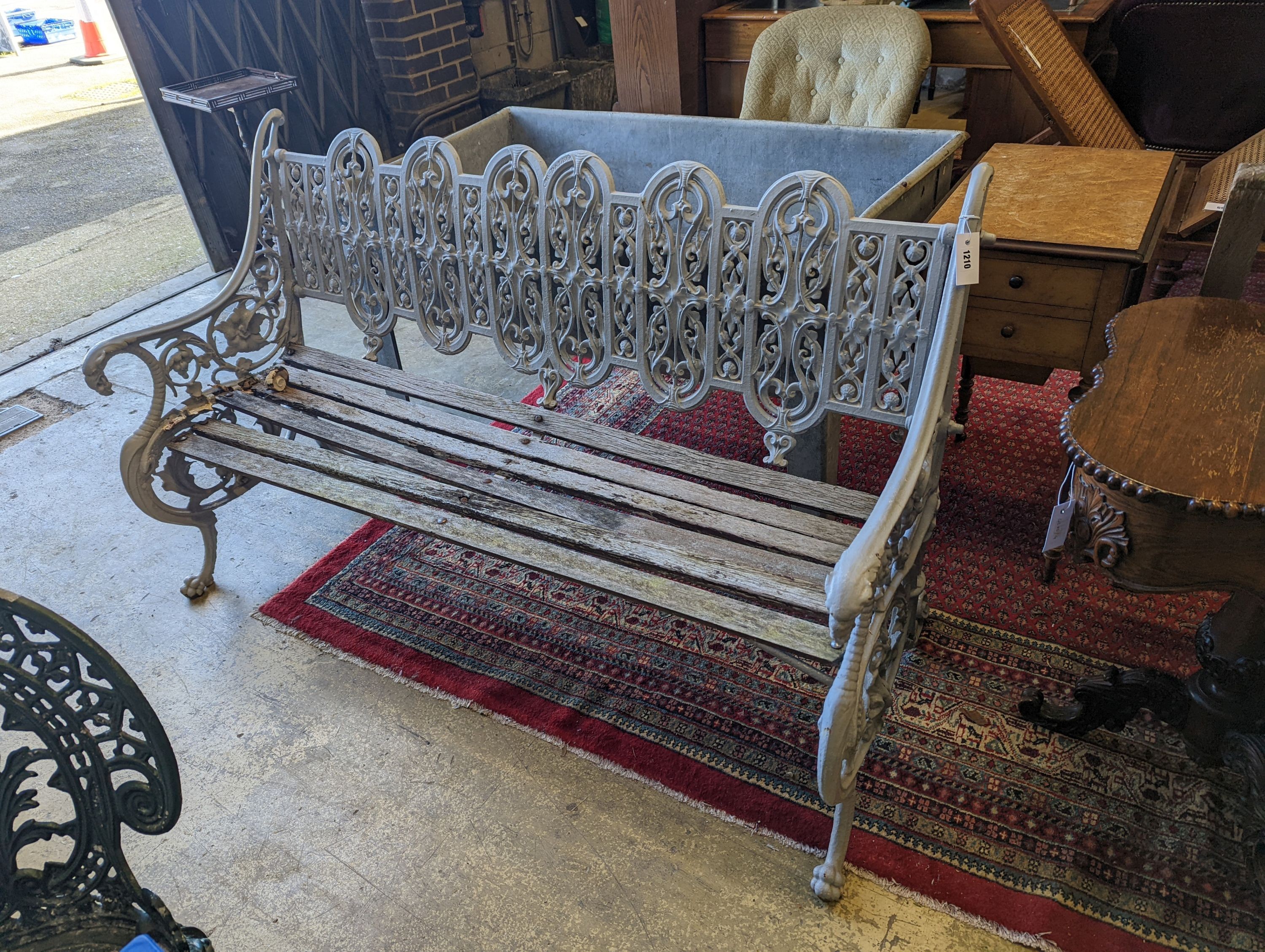 A Victorian Coalbrookdale cast-iron garden bench, length 156cm, depth 68cm, height 94cm (re-painted and seat in need of repair)
